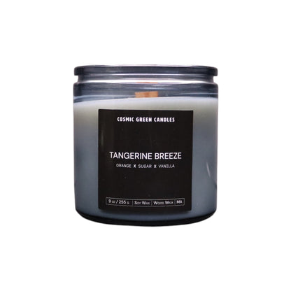 Tangerine Breeze candle in a vibrant orange jar, radiating a fresh citrus aroma.